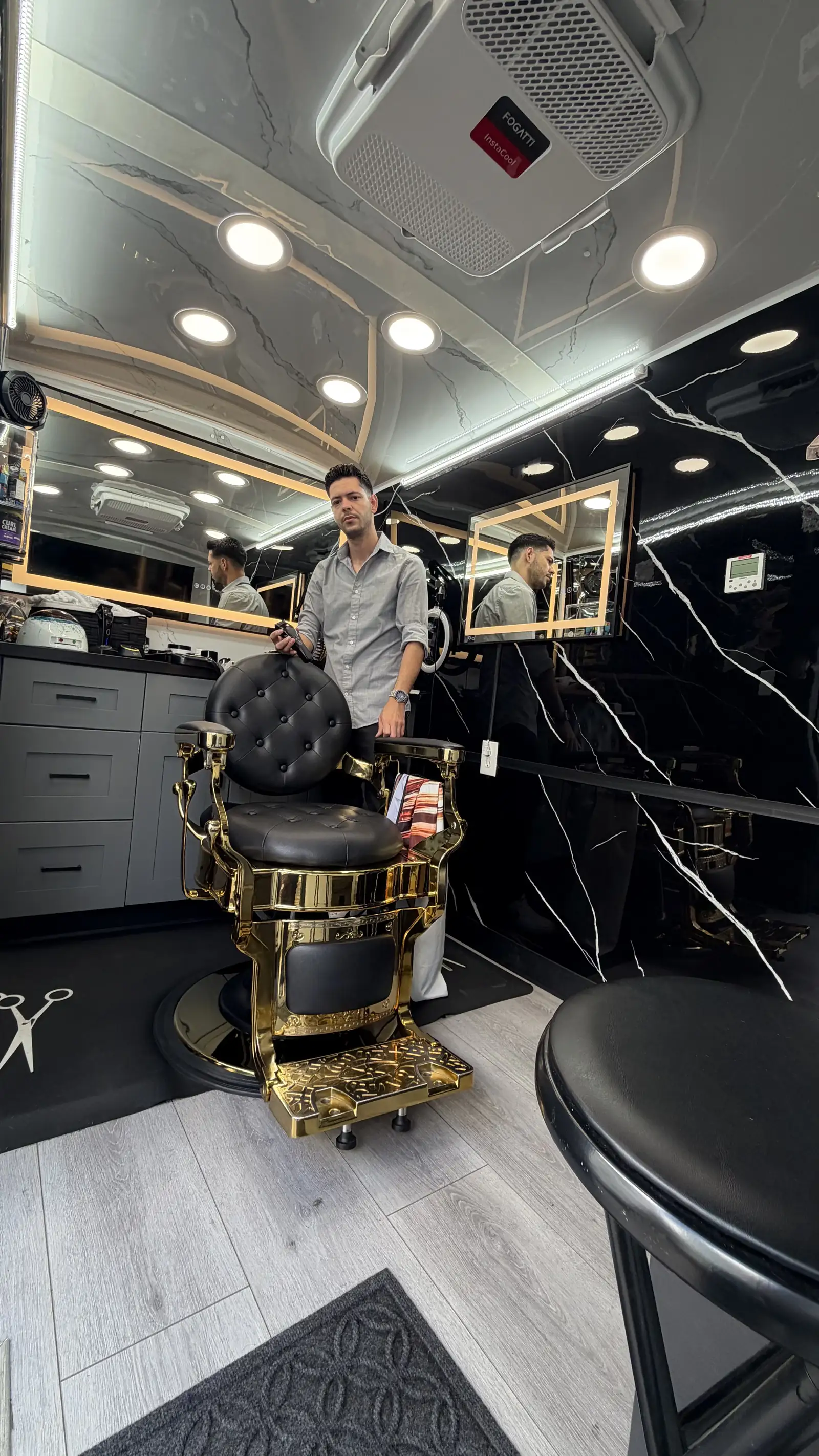 DJR owner at work inside the mobile barbershop