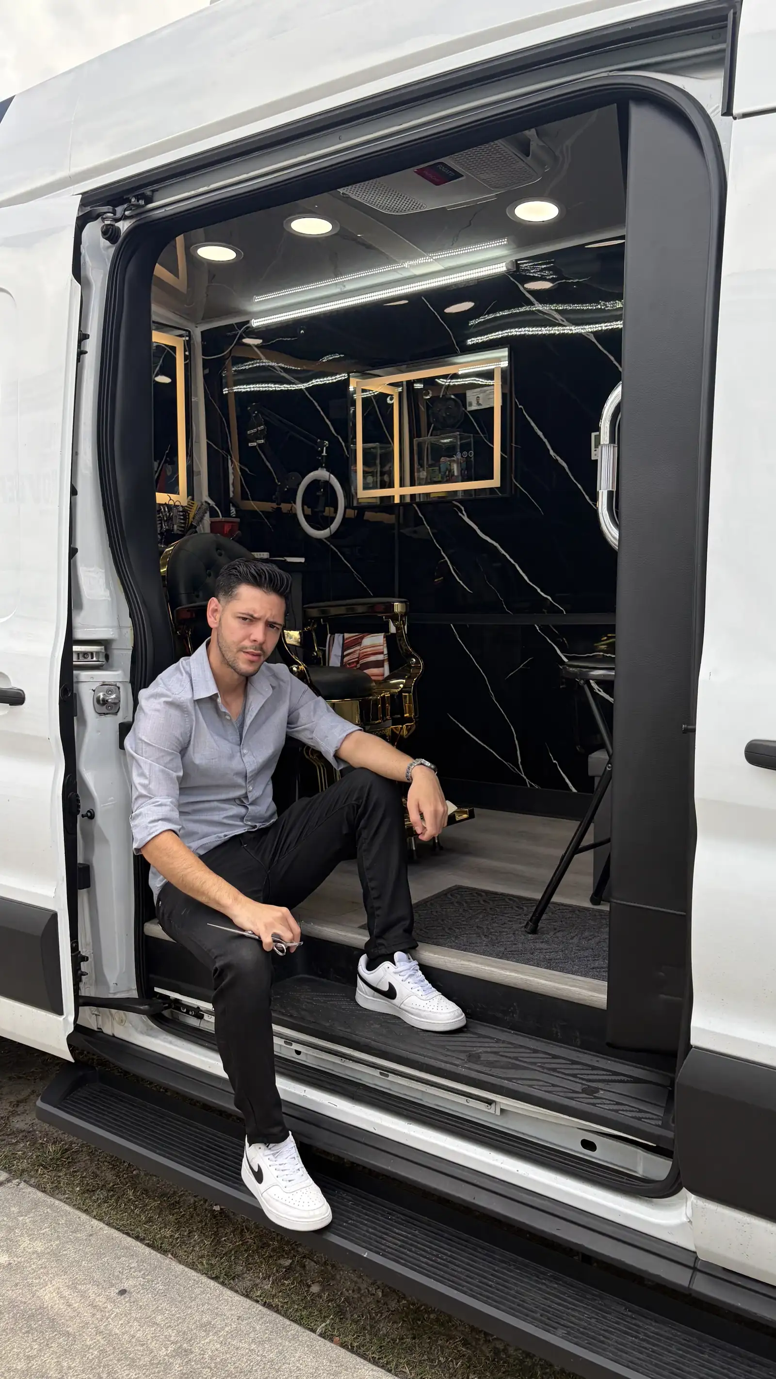 DJR owner at the door of the mobile barbershop